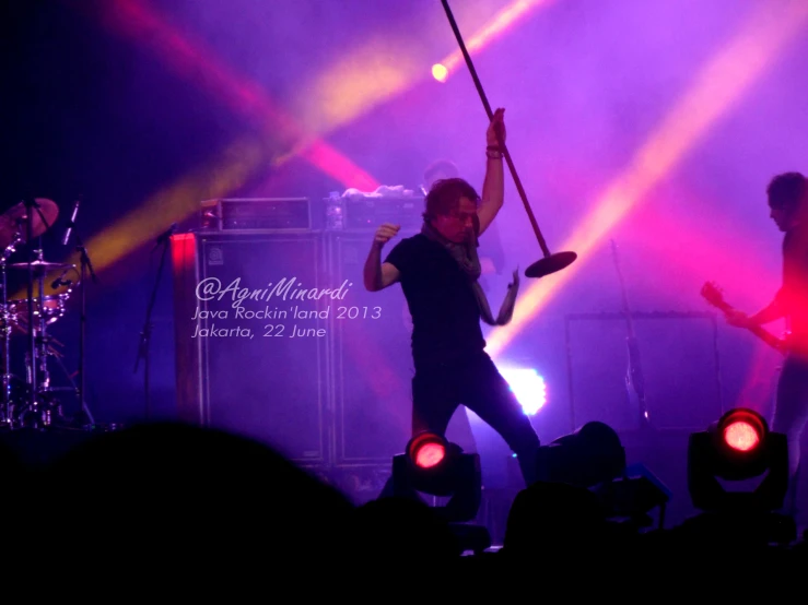 a person on stage holding up a pair of scissors