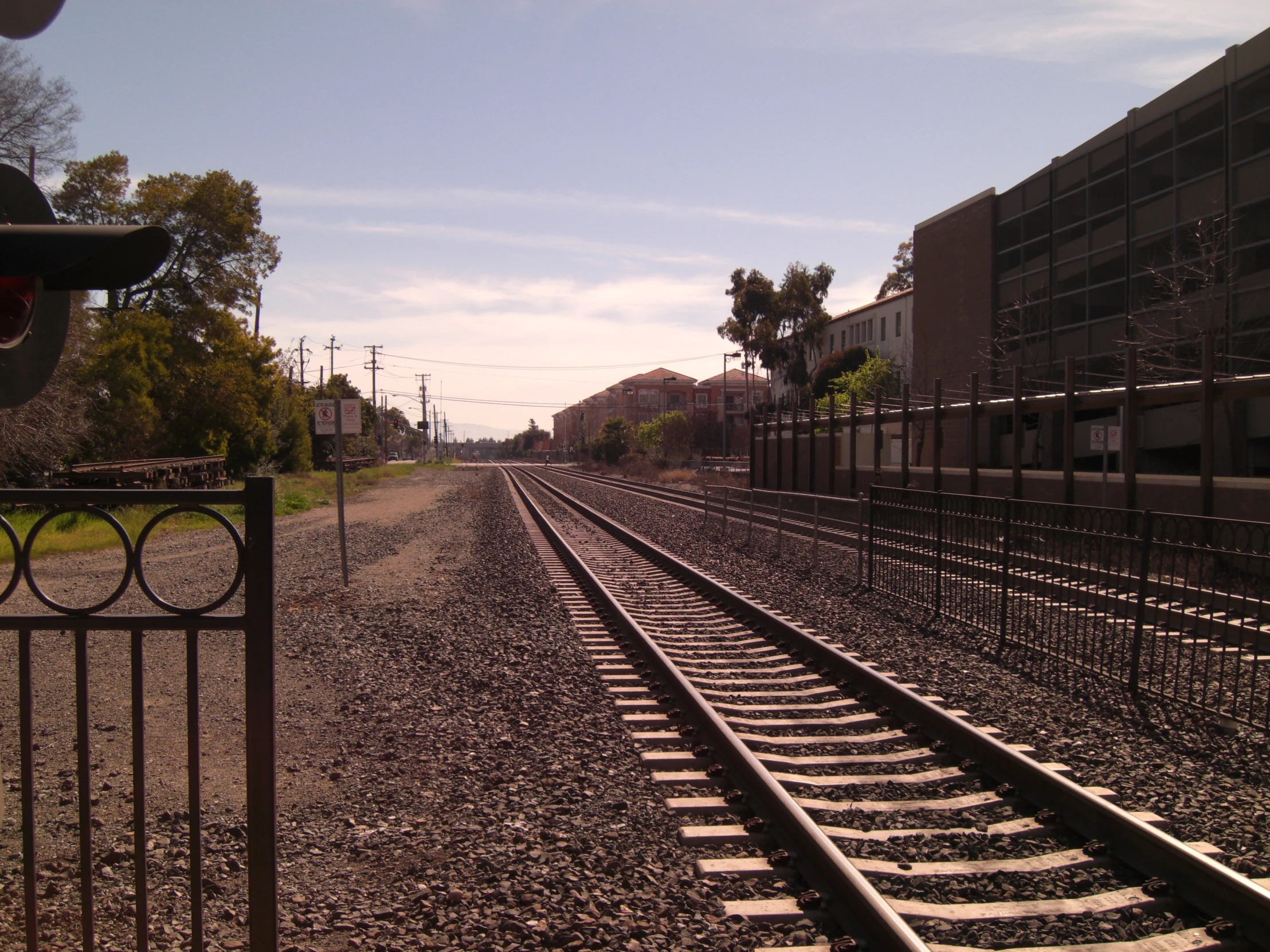 a train track is seen through a gate