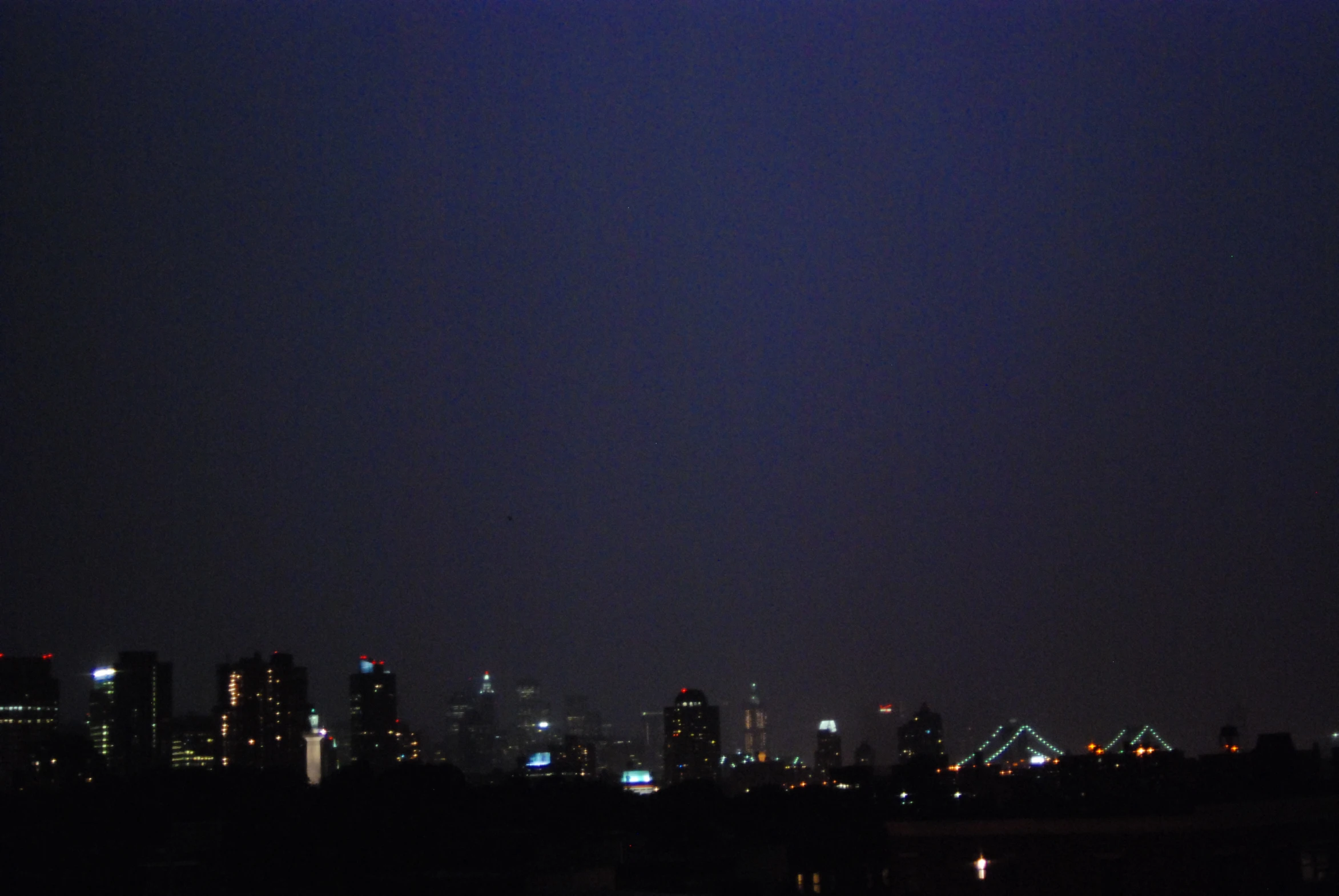 skyline view with dark sky and bright lighting at night