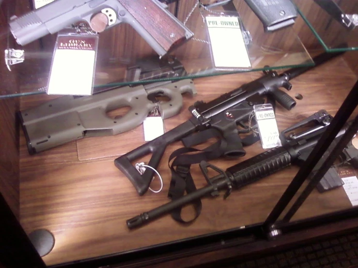 an assortment of handguns displayed on display on the table