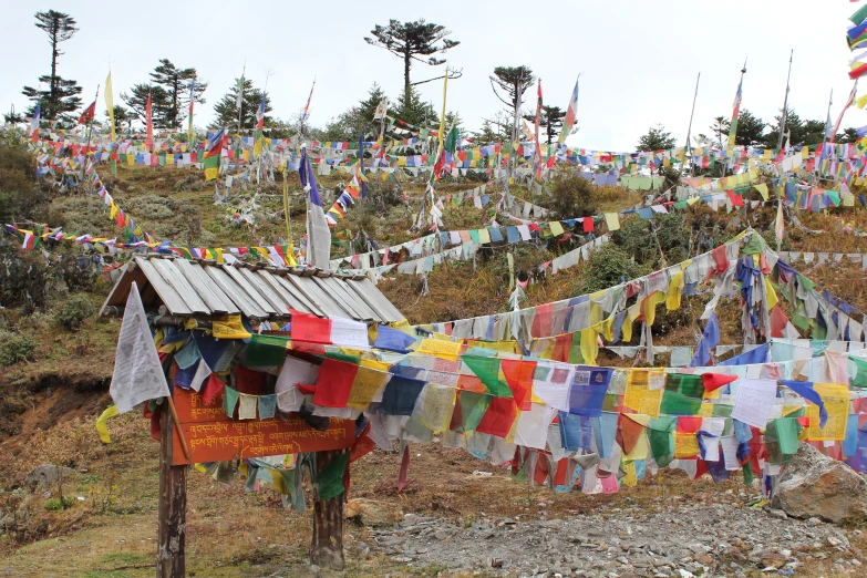 there is a small hut that has many flags around it