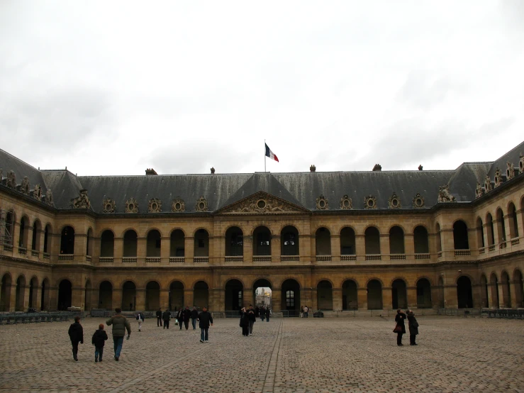 an old courtyard with many people inside and one is a building