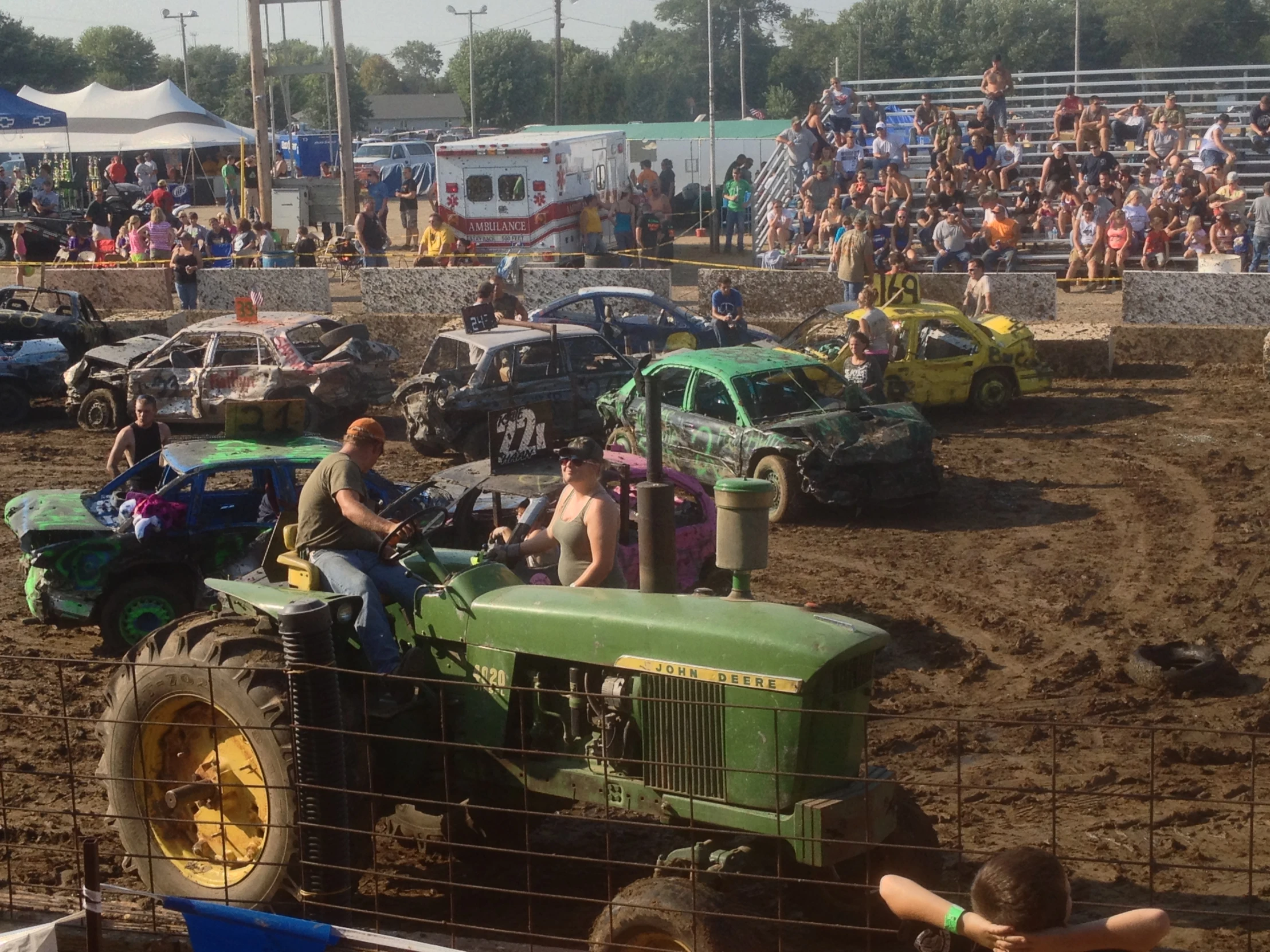 spectators watch as tractors sit idle during the muddy monster