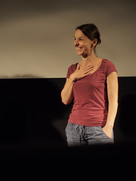 a woman posing while she smiles for the camera