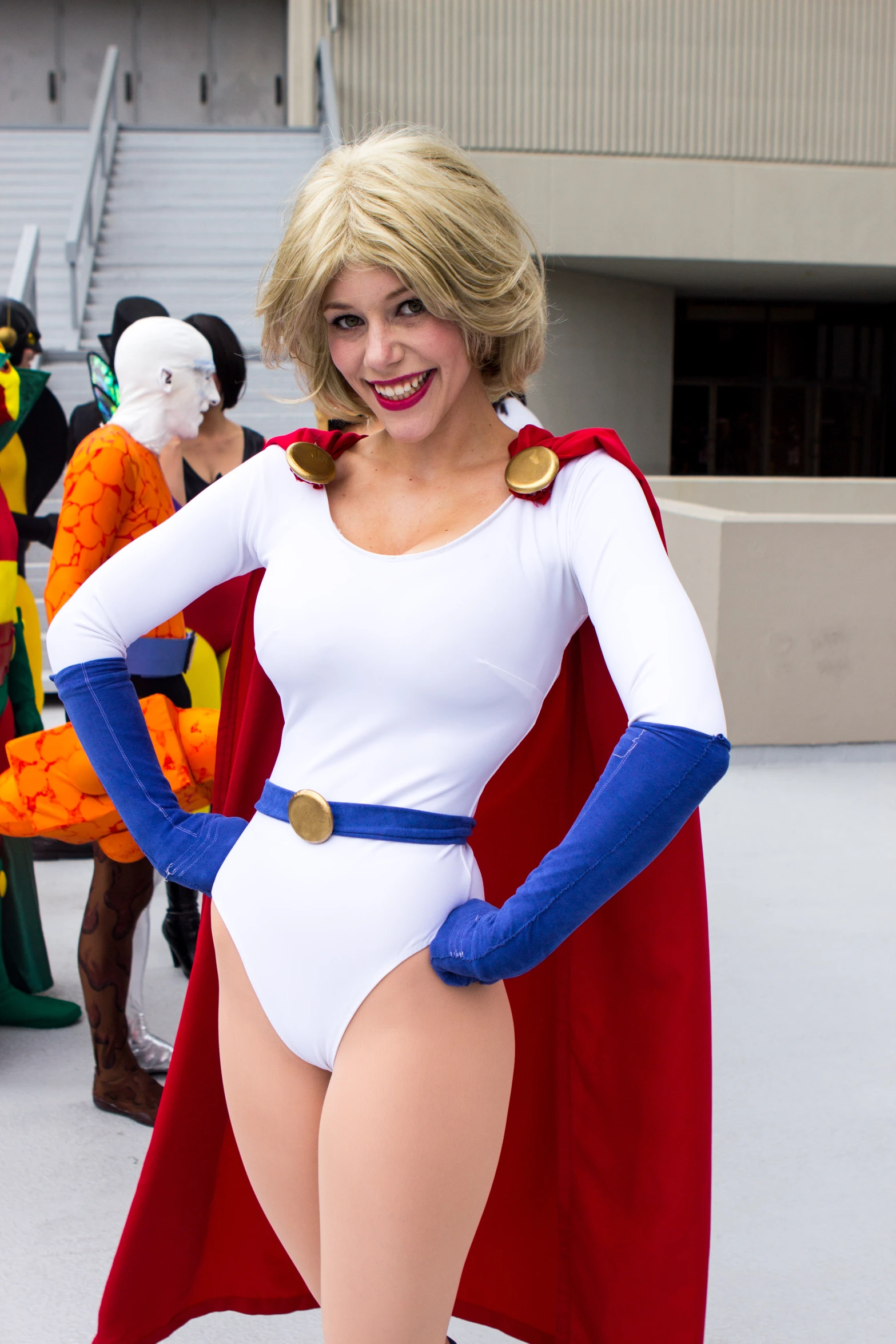 a woman dressed in superhero costumes standing outside