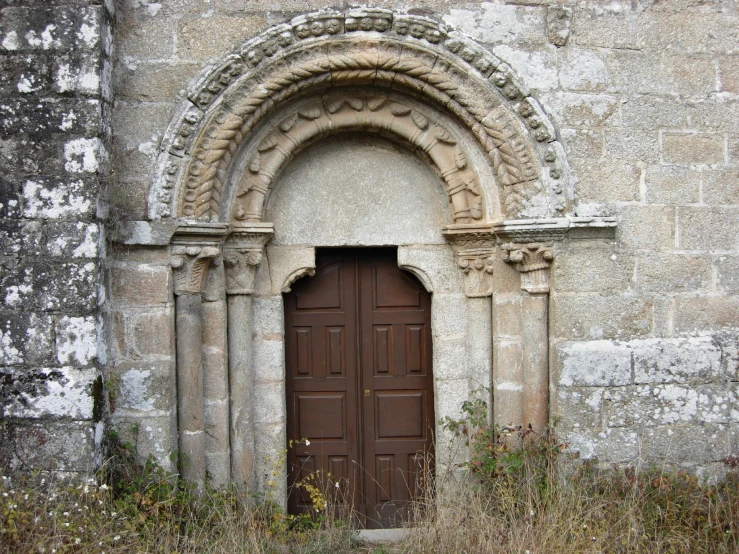 a wooden door sitting between two tall buildings