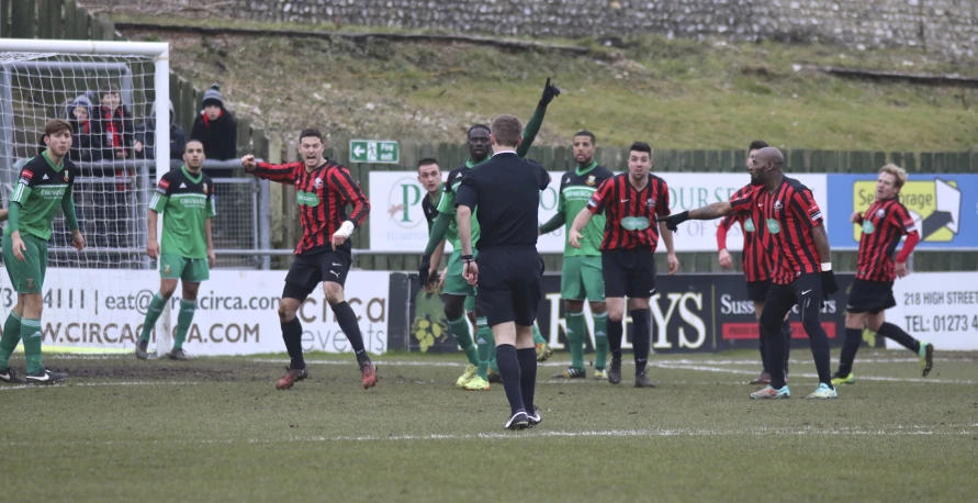 a soccer team celetes after a goal during the game