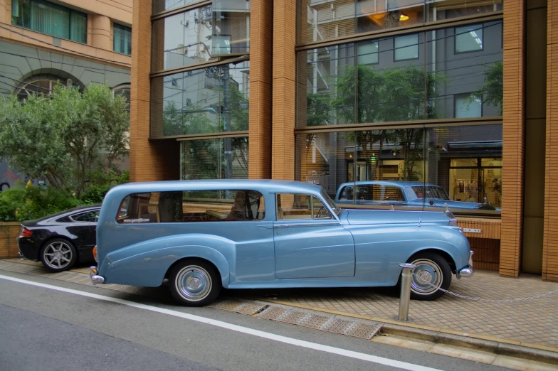 an older car parked in front of a building