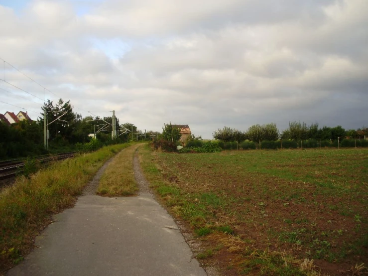 a long sidewalk in the middle of a field