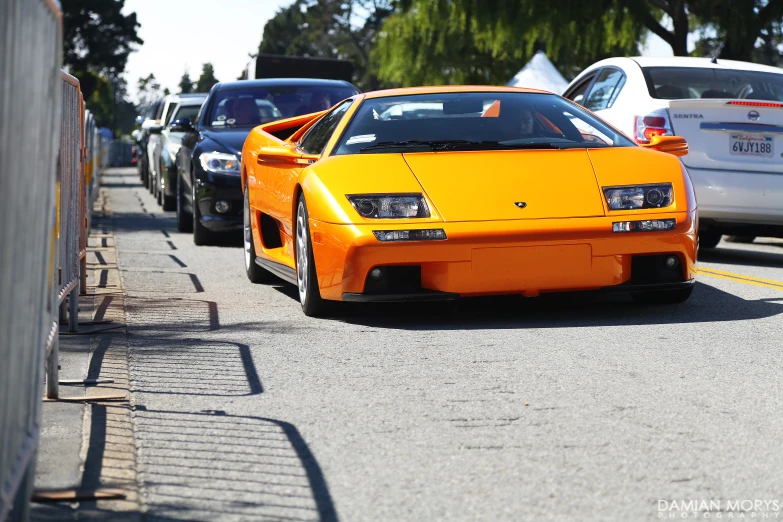 a very nice orange car on the street