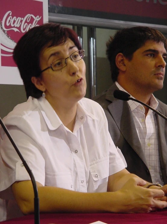 a woman is wearing a bow tie and holding a microphone