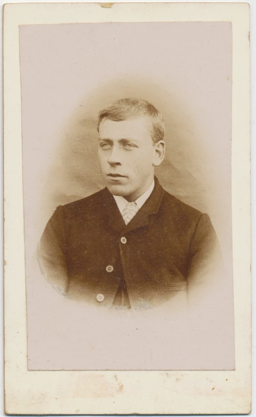 a sepia po of a man with short hair wearing a suit