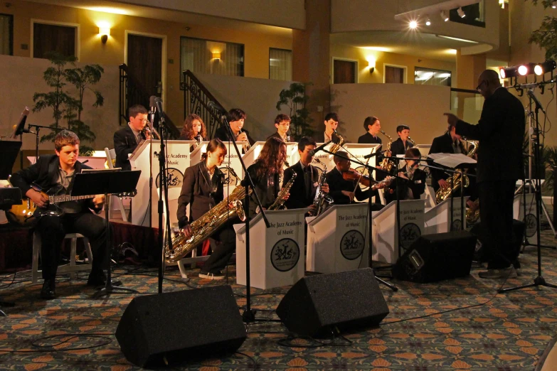 the band, musicians, and orchestra playing on stage