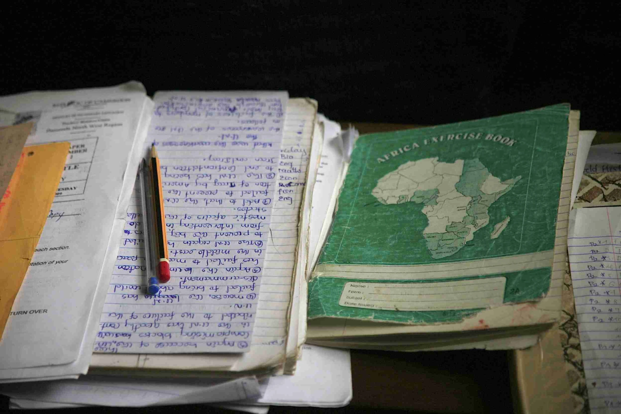 a bunch of books with pen on top of them