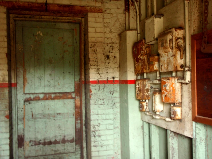 an old door sits in front of two worn out doors