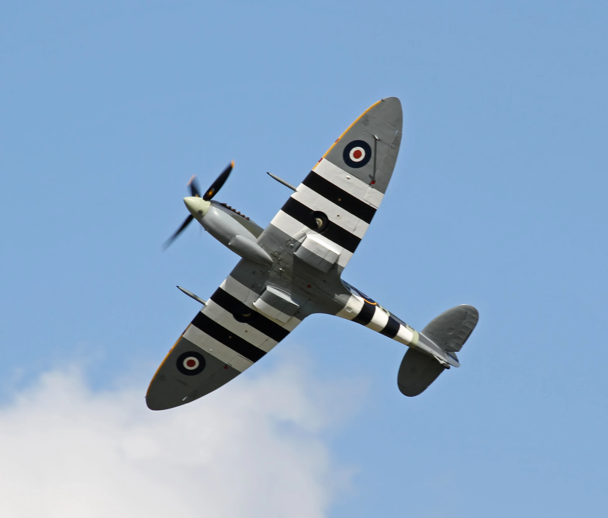 an old airplane flies through the air on a clear day