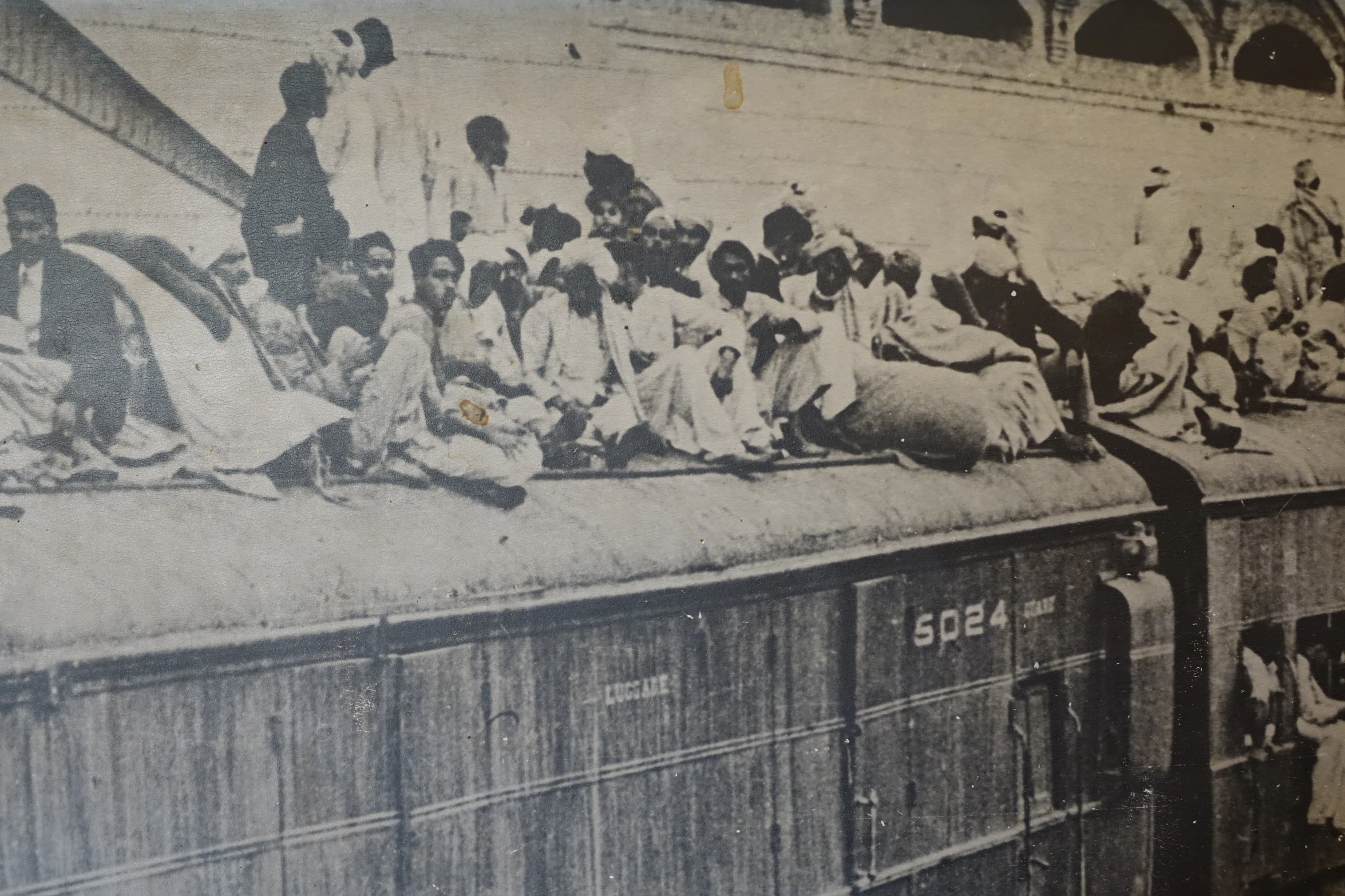 a long train with several people on the side of it