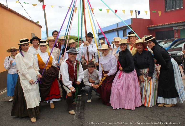 several people dressed in dress clothes posing for a picture