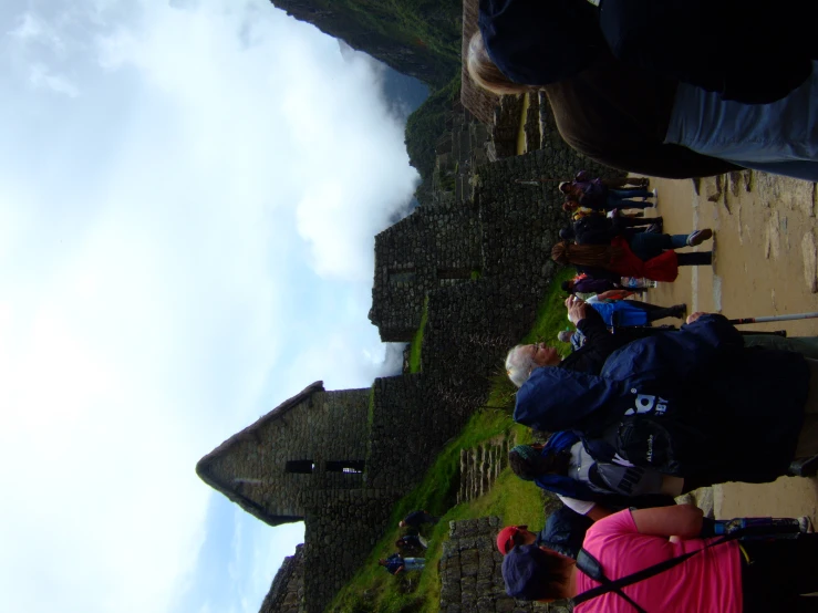 a group of people standing on a field next to a tall structure