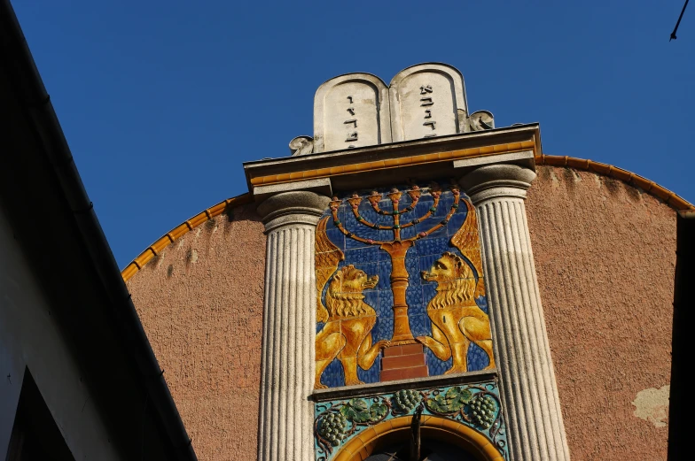 a large clock tower with columns and a giant hantzh