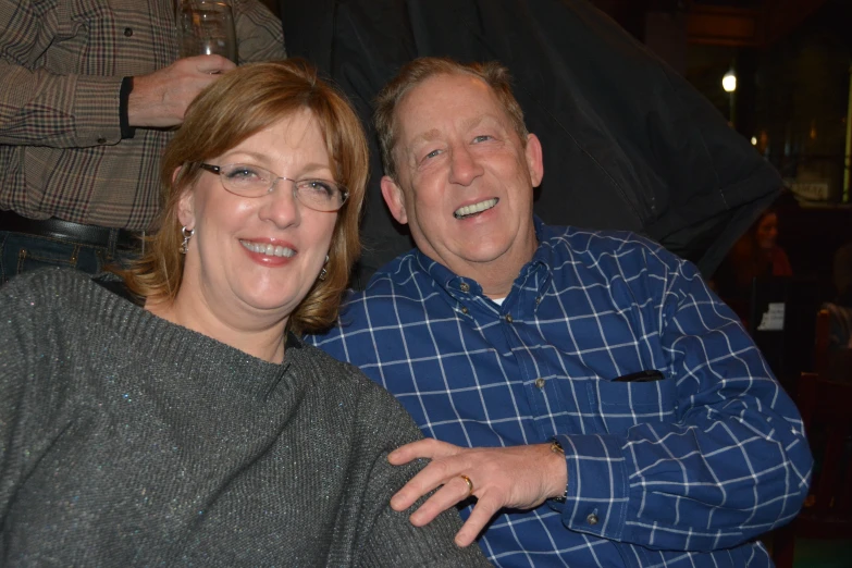 a man sitting next to a woman who is smiling