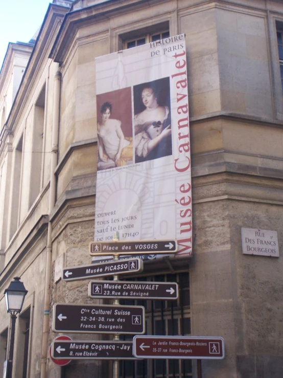 signs pointing to different locations outside of a building