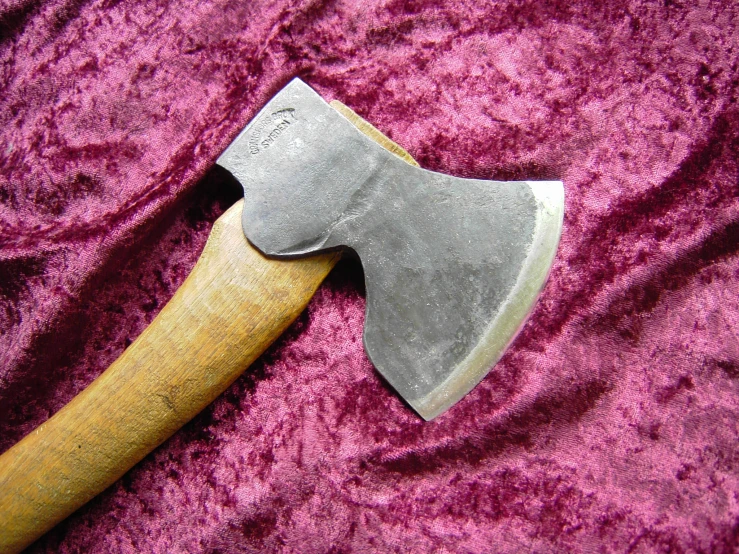 an old axestick lying next to a small hammer