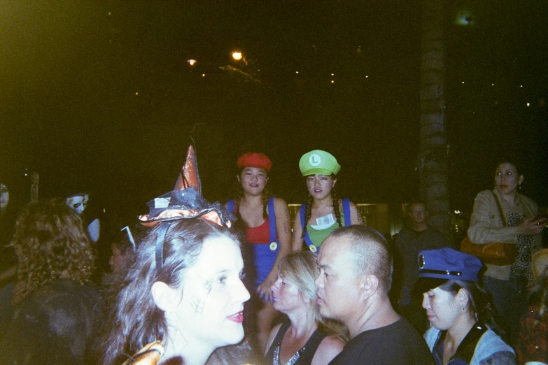 a group of people at a concert are wearing party hats