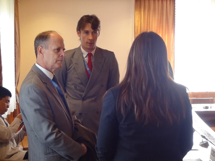 several people are talking at a business meeting