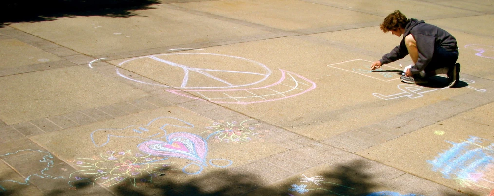 a  is drawing on the pavement