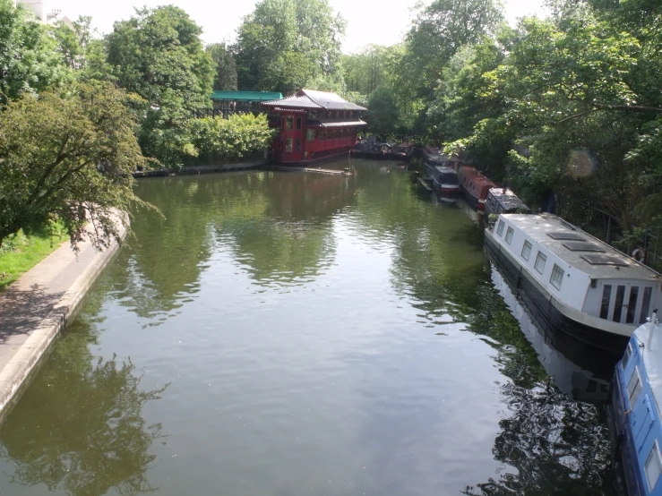 two boats docked along the bank of a river