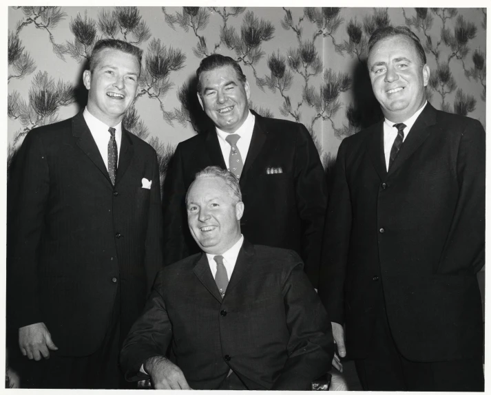 black and white pograph of five men in suits