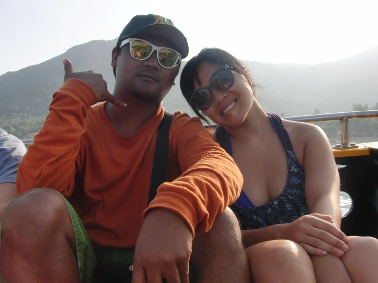 a man and a woman sitting on a boat