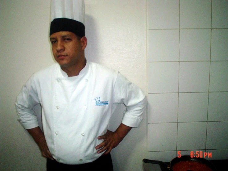 a man wearing a chef hat in a kitchen