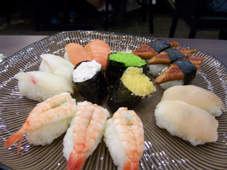 a plate is displayed with different types of sushi
