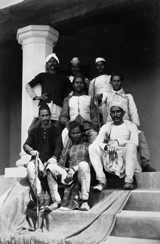 a group of men sitting next to each other on steps