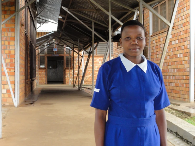 a woman stands in an open air shelter