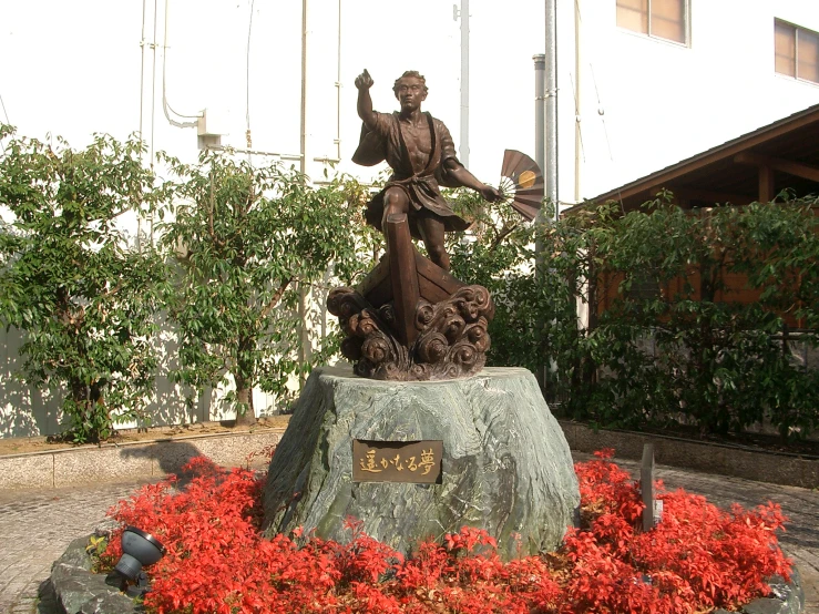 a large statue is placed in a garden