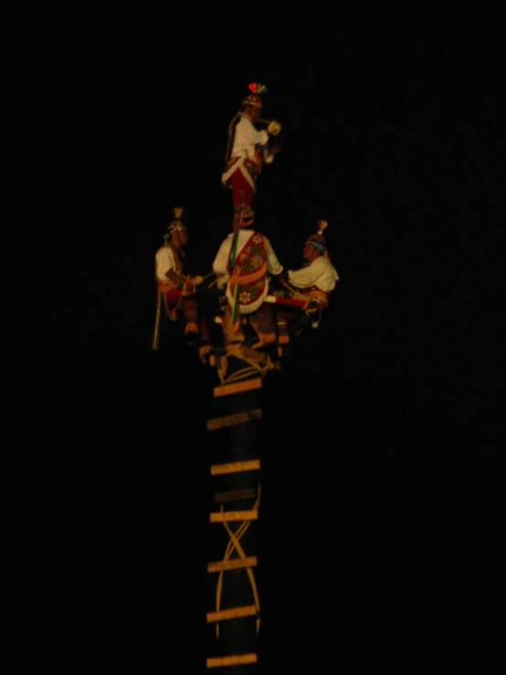 a clock tower is shown at night with people