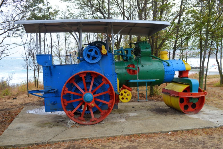 a train sits in front of some trees and water