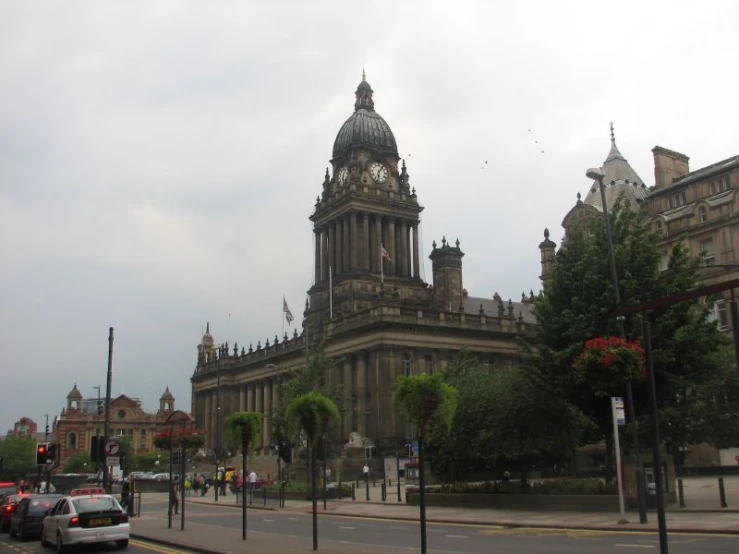 a clock on a building that is sitting in the middle of a city