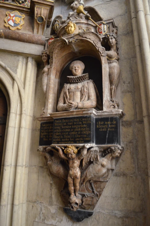 the statue is on the wall of the building