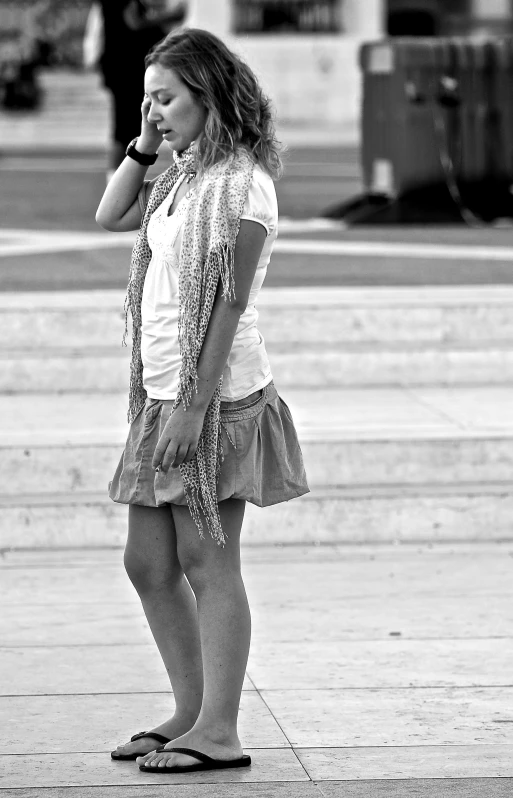 a woman is on her phone while walking down the street