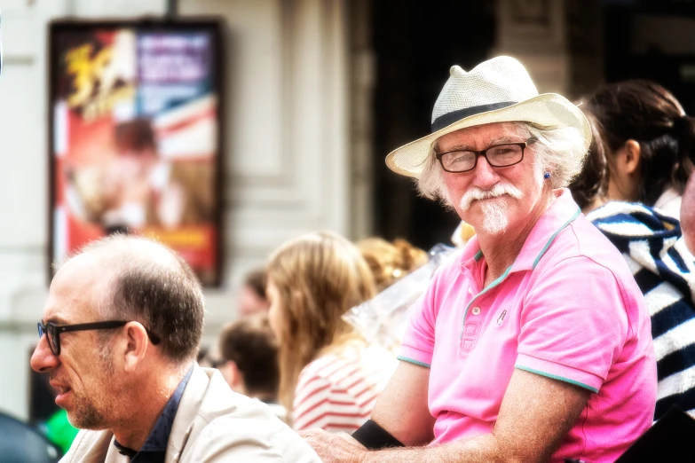 an older man wearing a straw hat and glasses