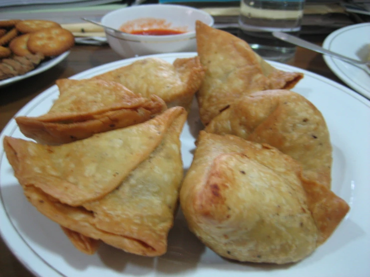 fried pastries on a plate with some dipping sauce