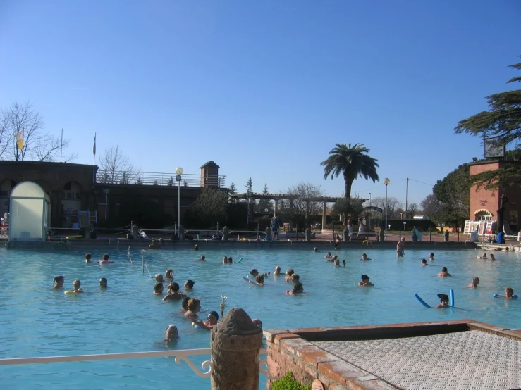 a group of people swimming in a large, deep pool