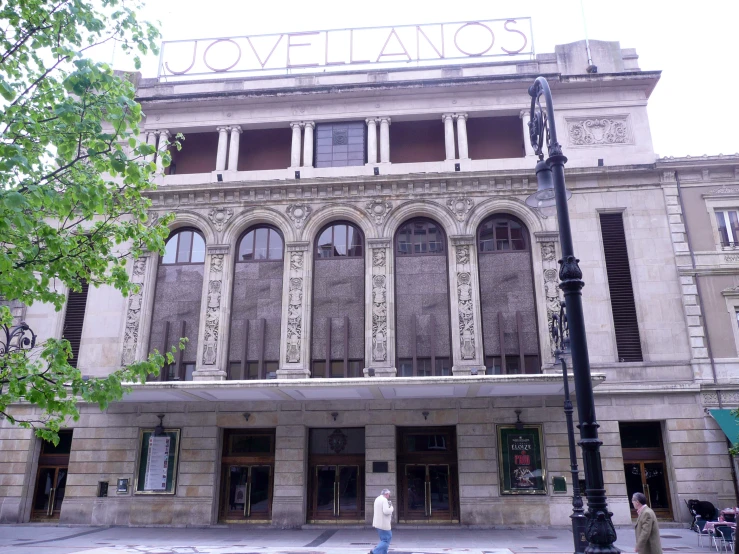 a large brown and white building on the corner of the street