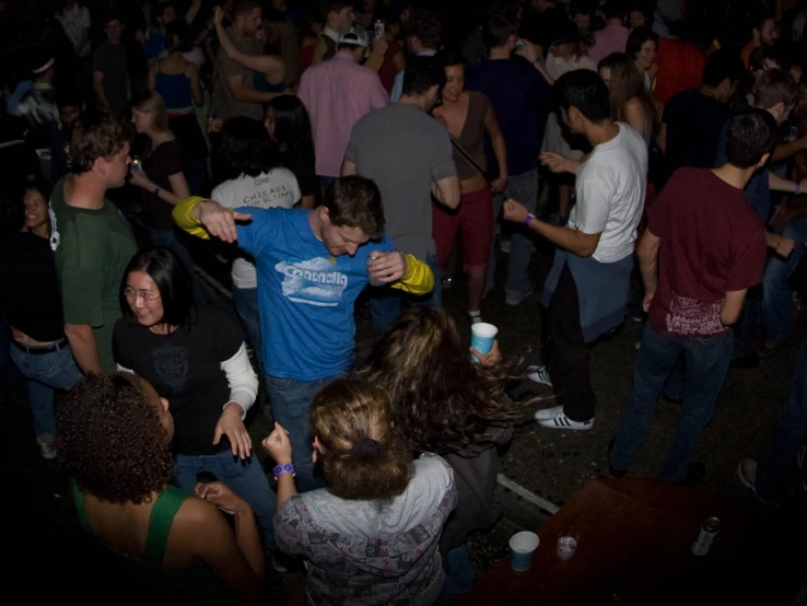 people dancing at night in a crowded city