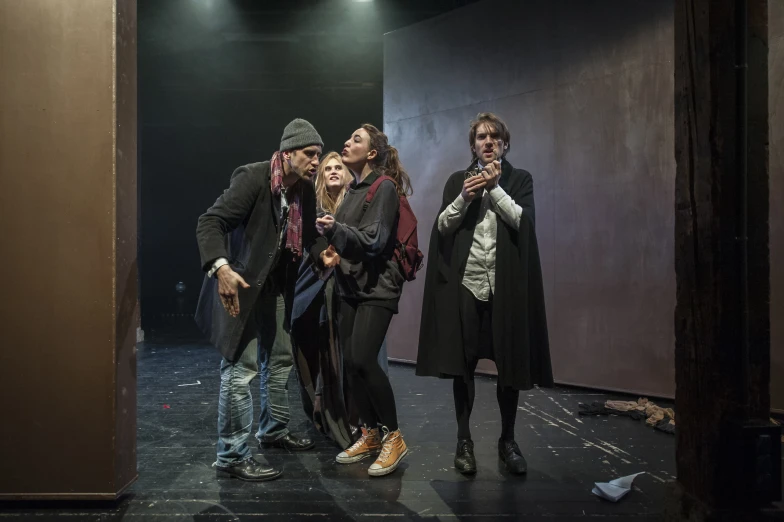 a group of people standing next to each other in a dark room