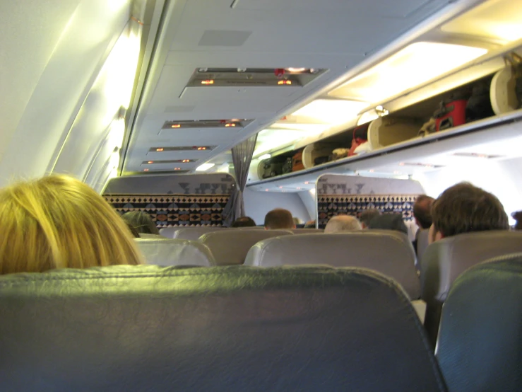 passengers sitting in airplane on a cloudy day